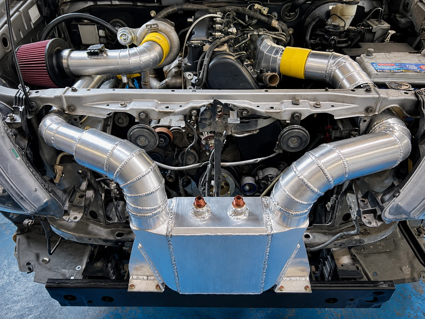 Custom aluminum intake fabrication in an engine bay