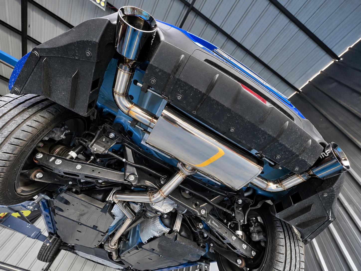 A specialty muffler setup under a vehicle