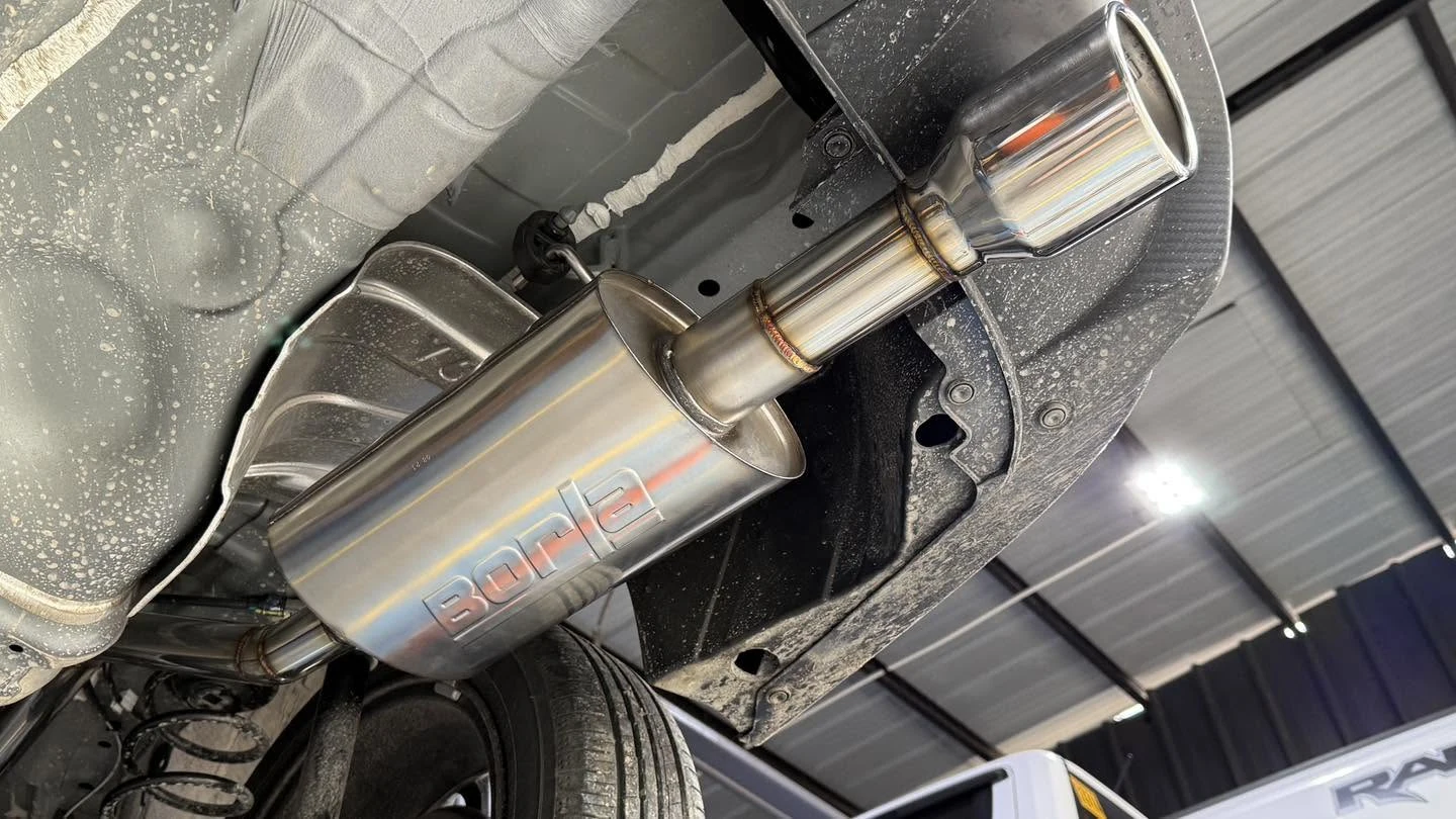 A Borla muffler installed under a pickup truck